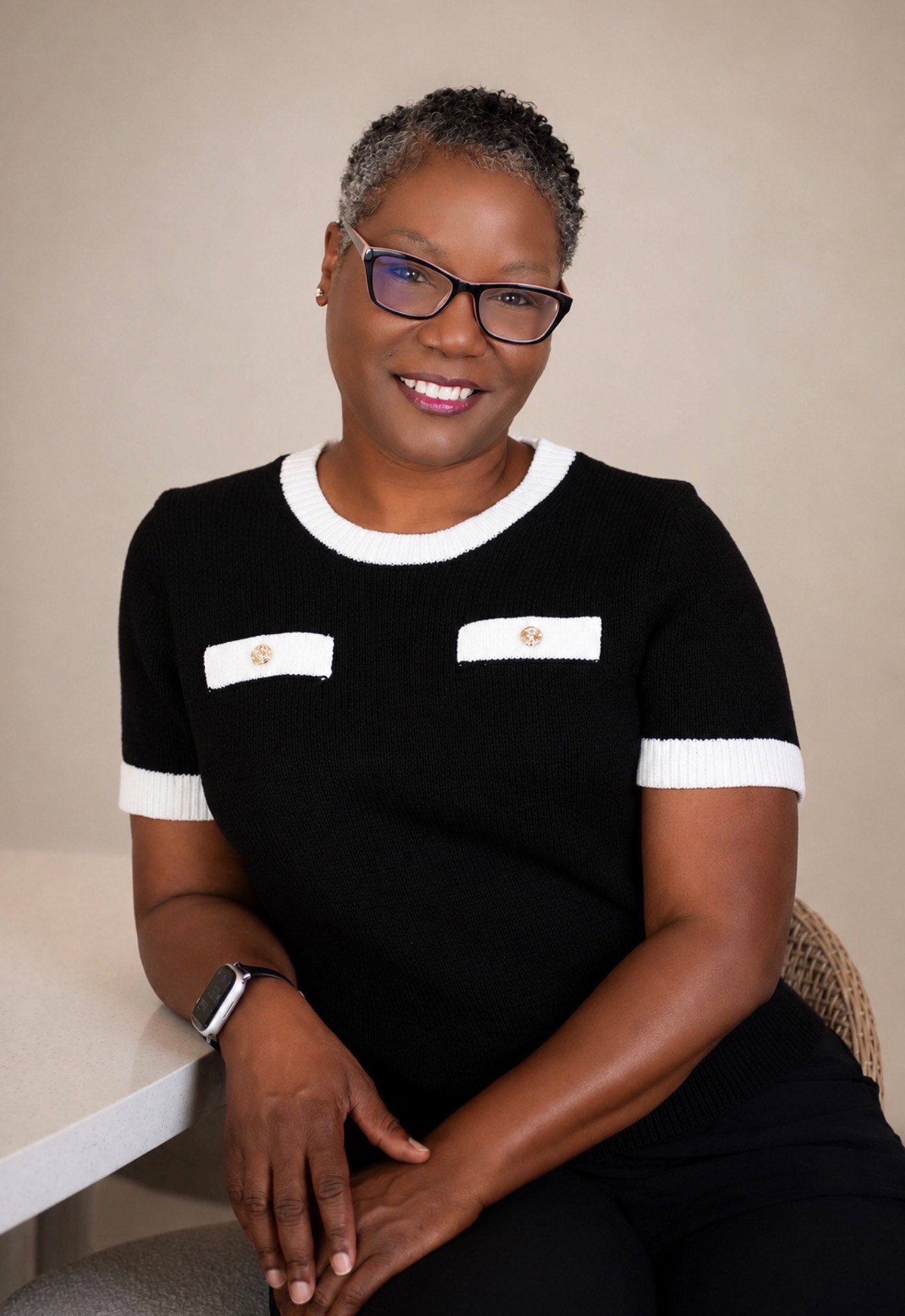 Crystal Carroll, EMERGE Summit featured speaker, smiling in a black and white top
