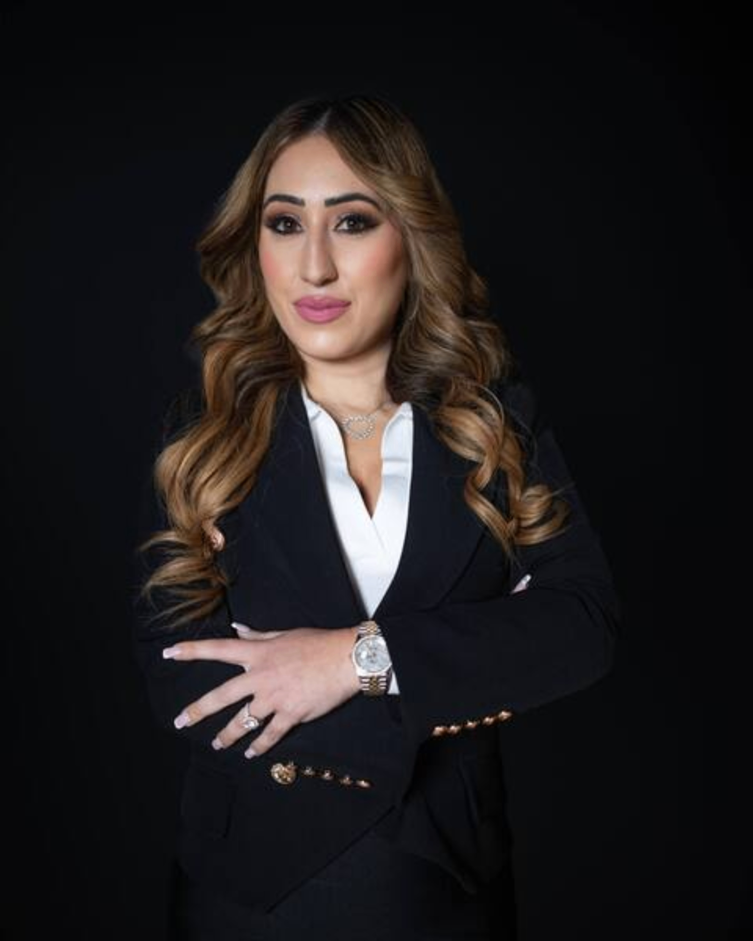 Rachel Michaelov, EMERGE Summit featured speaker, in a black blazer with arms crossed