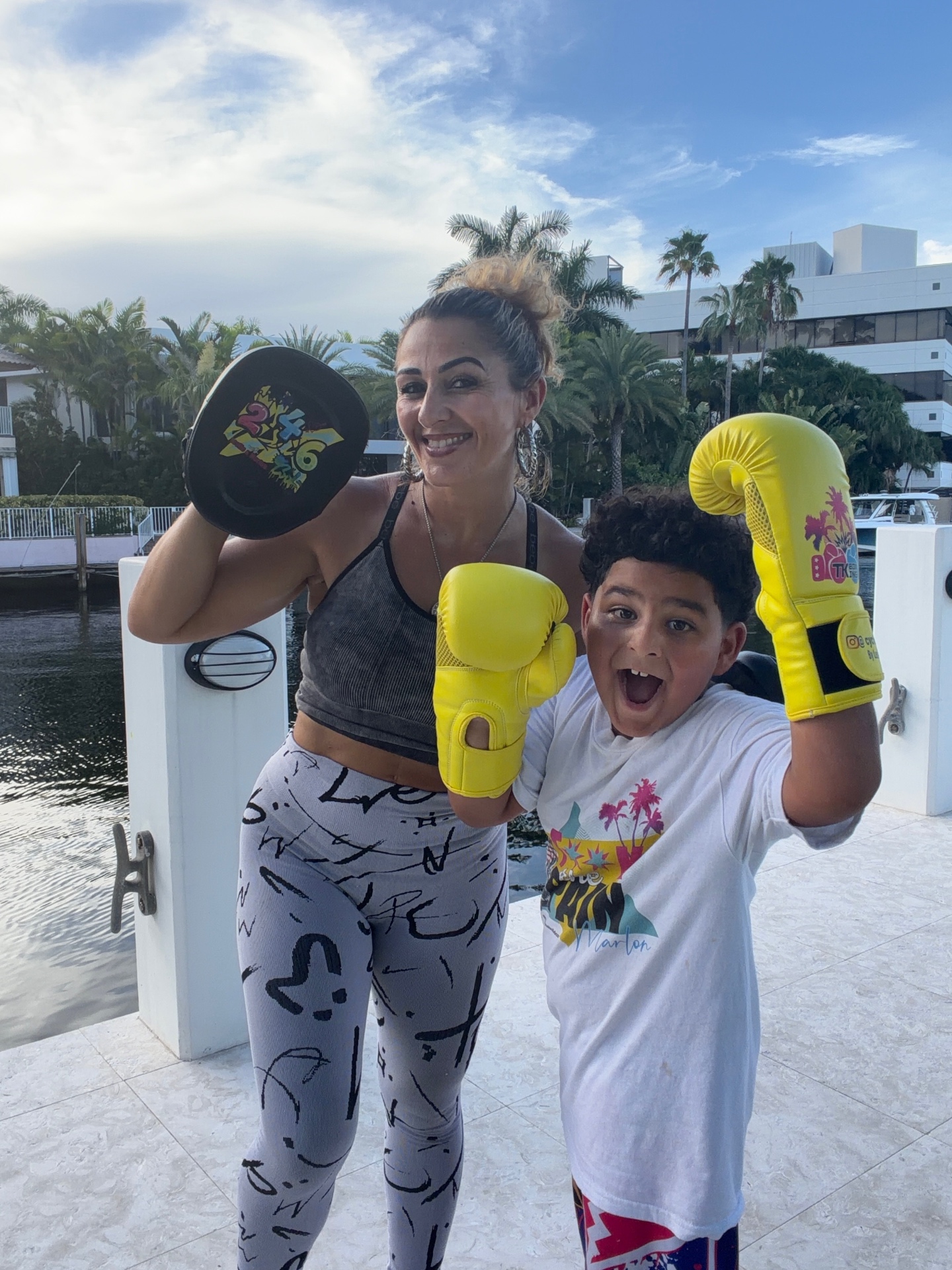 Young boxer celebrating with yellow gloves after a session